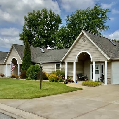 Exterior view of a senior living building with gardens