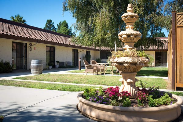 Outdoor courtyard with a fountain and seating