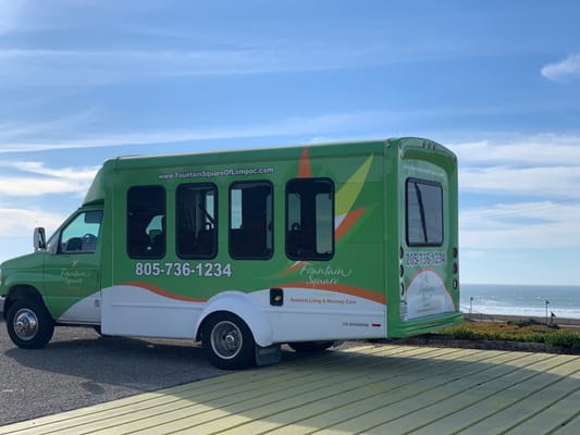 Facility shuttle bus parked by the ocean