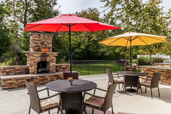 Outdoor patio area with umbrellas and seating