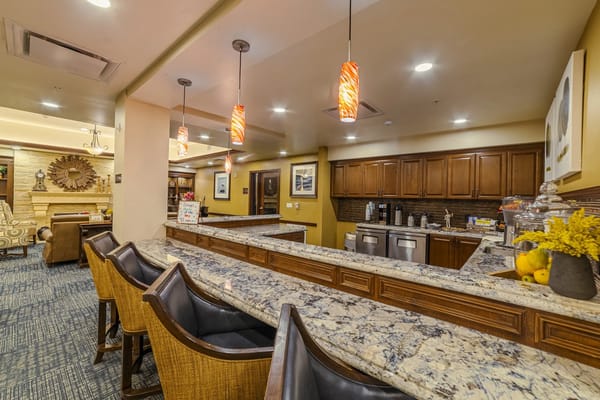 Bright common area with bar seating and kitchen