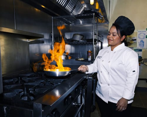 Chef cooking in the kitchen with flames