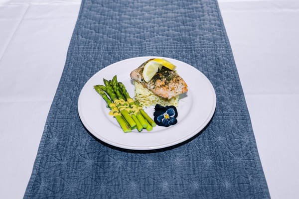 Plated meal of salmon with asparagus and lemon