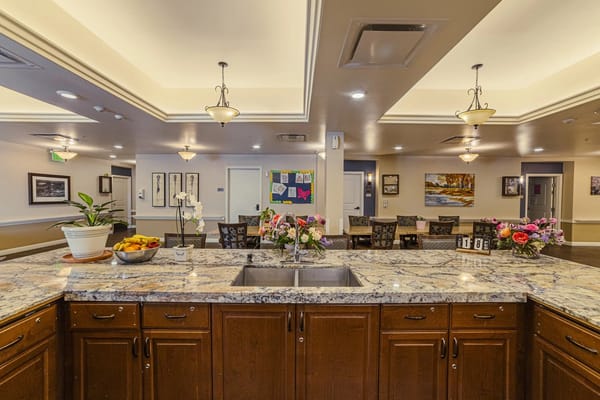 Bright dining area with flowers and granite countertops