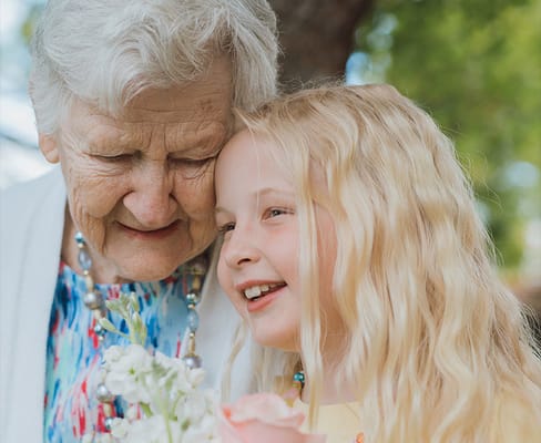 Elderly woman and young girl enjoying time together outdoors