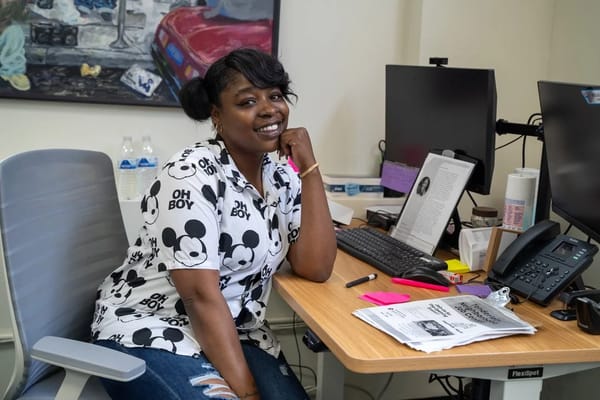 Staff member posing at a desk in the facility
