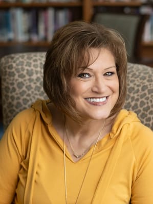 Smiling resident in a cozy lounge area