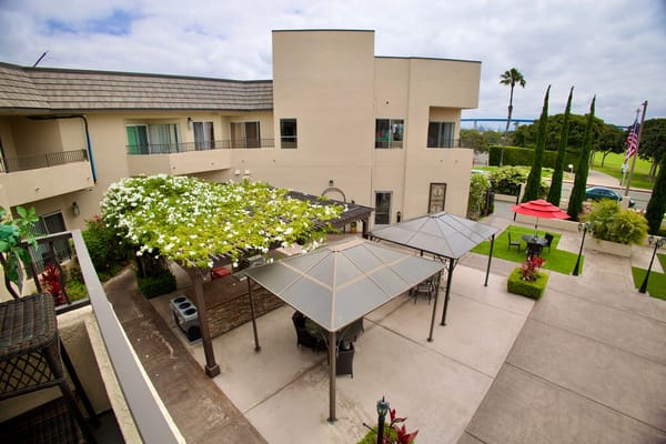 Outdoor patio area with seating and greenery