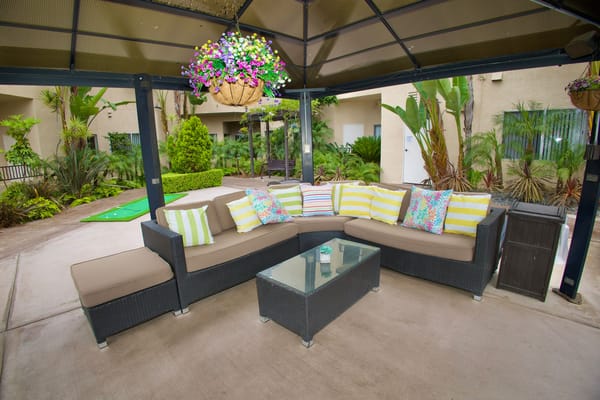 Outdoor seating area with comfortable couch and plants