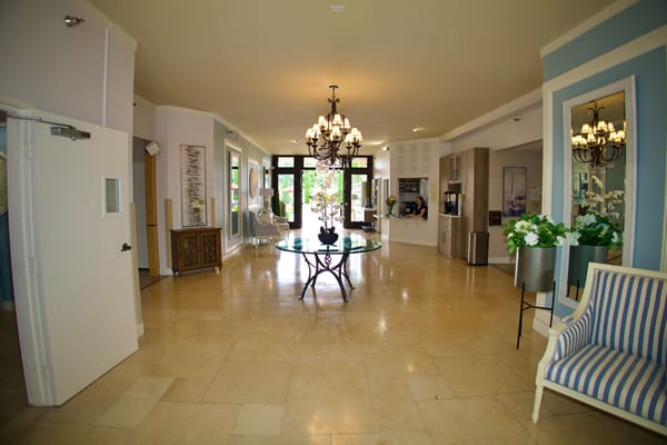 Bright lobby area with chandeliers and seating