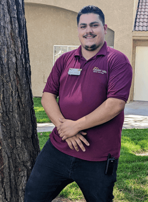 Staff member posing outdoors in front of a facility