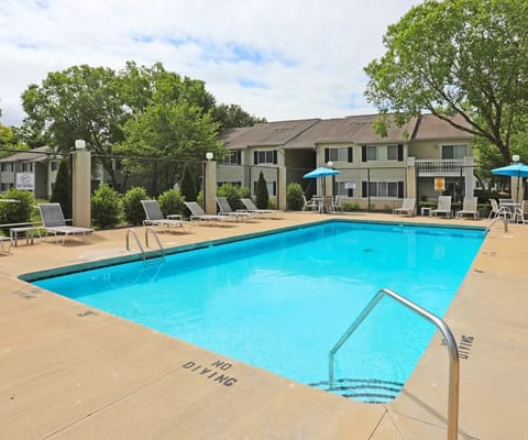 Outdoor swimming pool with lounge chairs and umbrellas