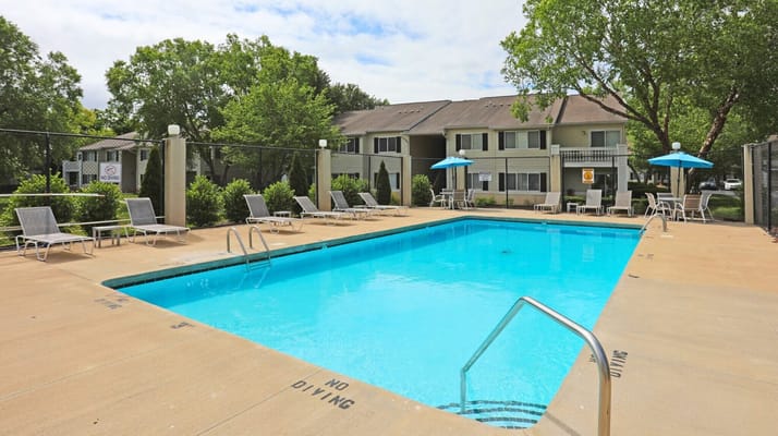 Outdoor swimming pool area with lounge chairs