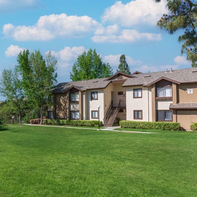 Exterior view of a senior living facility surrounded by grass