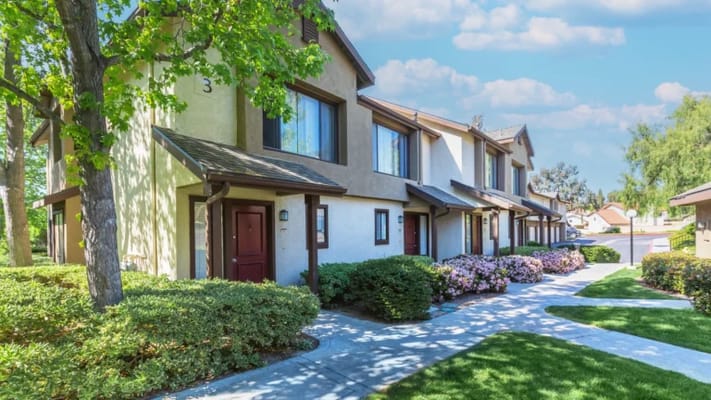 Exterior view of a senior living facility with landscaped pathways