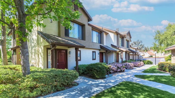 Exterior view of a senior living facility with landscaped pathways