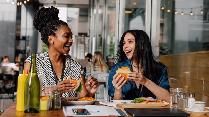 Two women enjoying lunch in a dining area