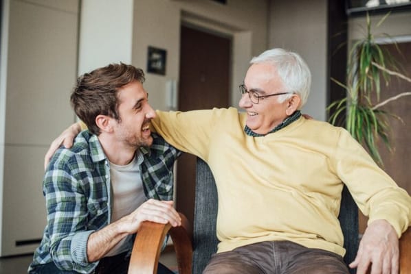 Two men enjoying a friendly conversation in a cozy room