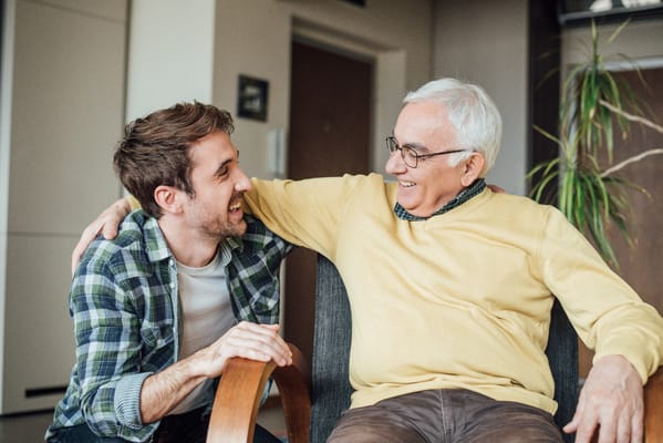 Two men enjoying a friendly conversation in a cozy room