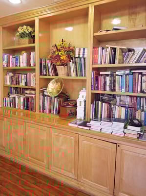 Bookshelves filled with various books and decor items