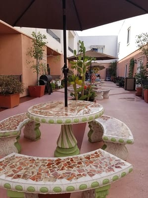 Outdoor courtyard with decorative seating and plants