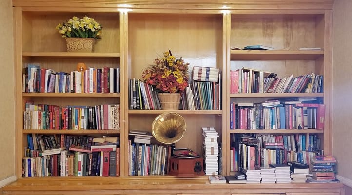 Bookshelves with various books and a vintage record player