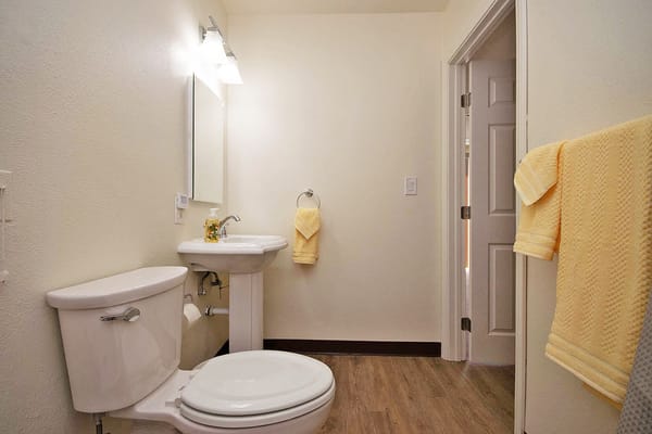 Bright and clean bathroom area with yellow towels