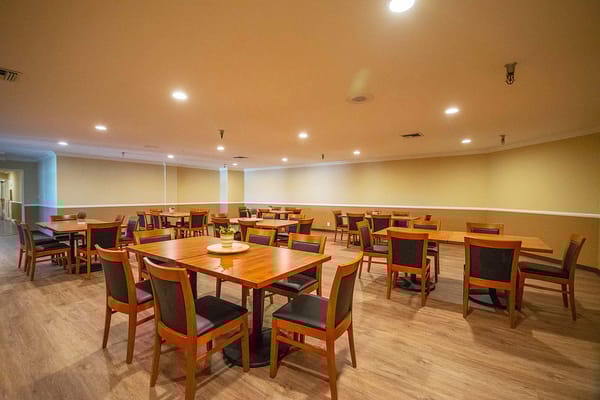 Bright dining area with wooden tables and chairs