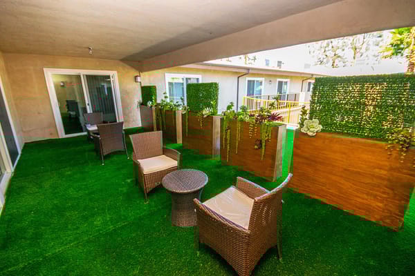 Outdoor seating area with greenery and decor