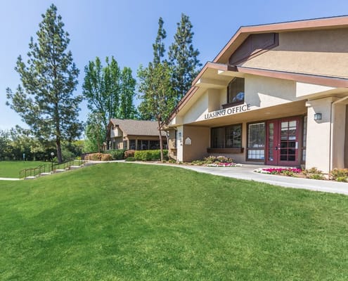 Exterior view of the Leasing Office surrounded by greenery