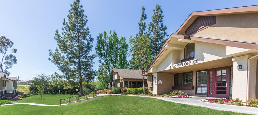Exterior view of the leasing office with landscaped grounds