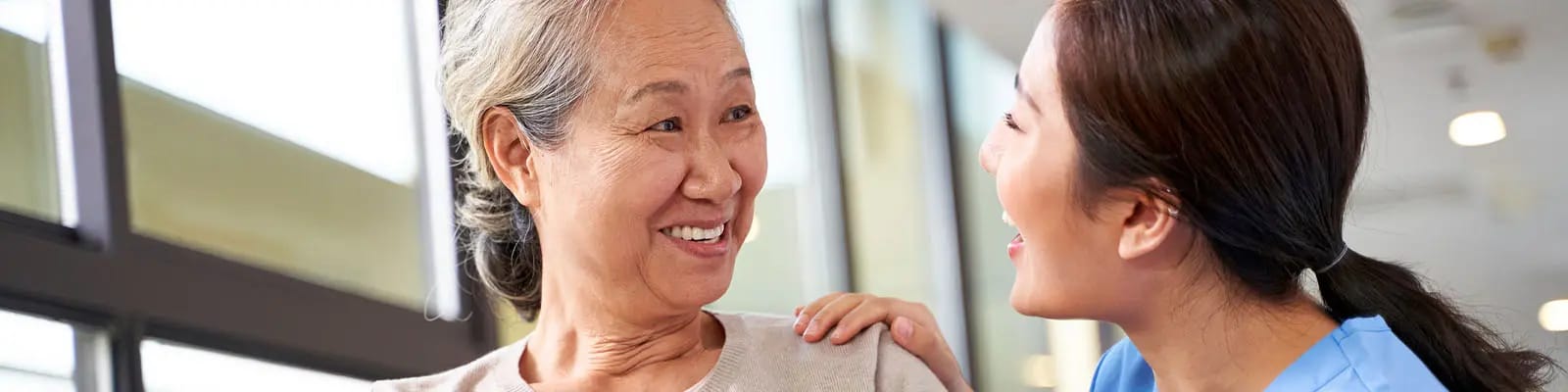 Caregiver and resident sharing a joyful moment