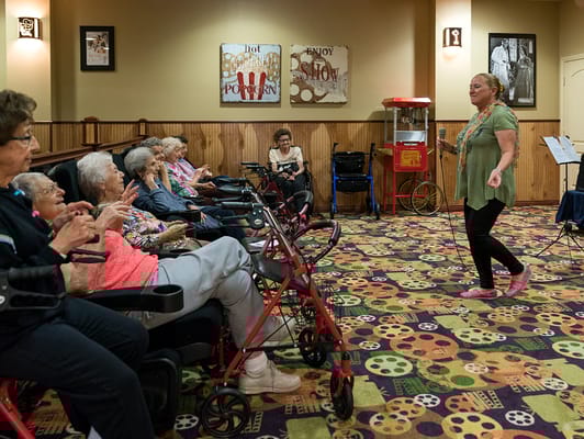 Residents enjoying an activity with a performer
