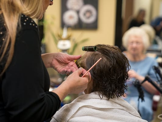 Styling a resident's hair in the salon