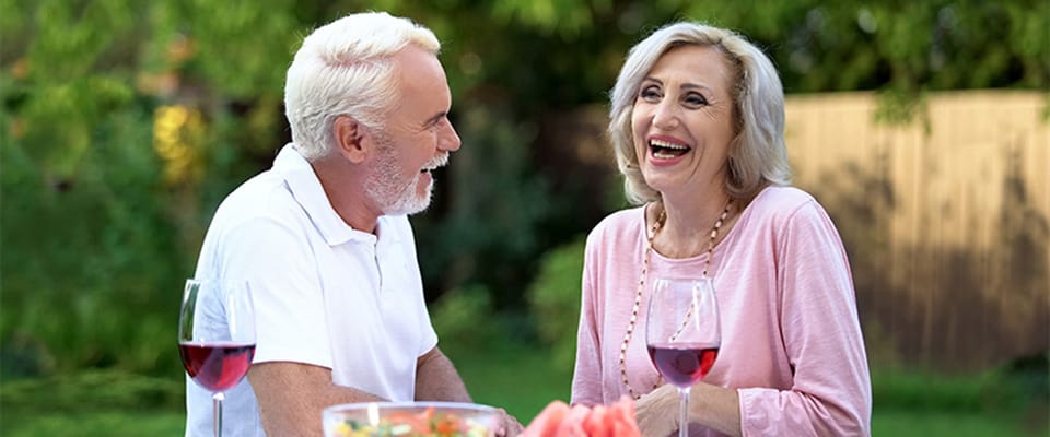 Residents enjoying conversation outdoors with drinks