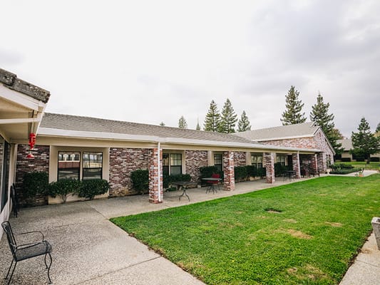 Outdoor area of a senior care facility with landscaped grounds