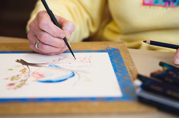 A resident engaging in an art activity