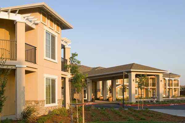 Exterior view of the assisted living facility with gardens