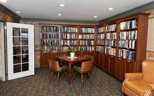 Cozy library area with bookshelves and a table