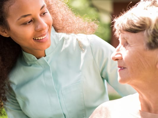 Caregiver interacting with a resident outdoors
