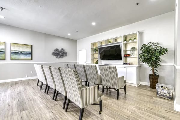 Interior view of a common area with seating and a TV