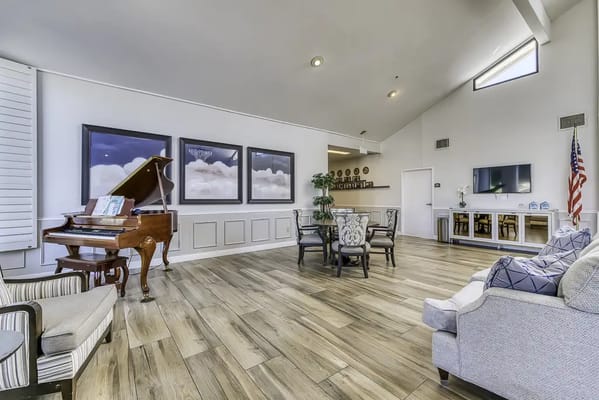 Bright common area with seating and a piano