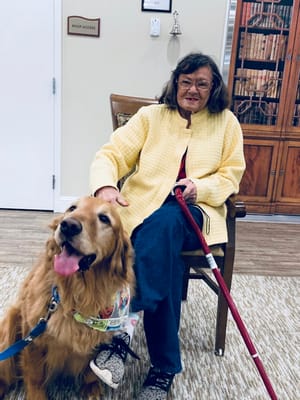 Resident interacting with a dog in a cozy interior