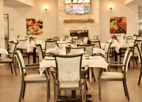 Dining area with tables and chairs set up for meals