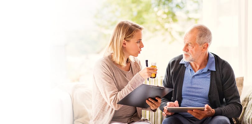 A caregiver discussing with a resident in a cozy setting