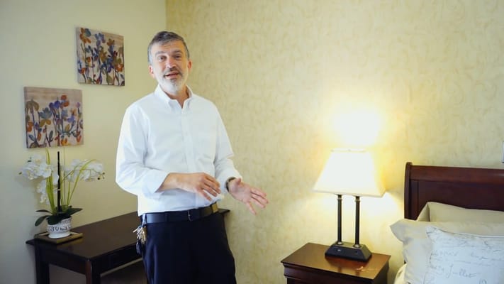 Staff member in a well-lit resident room