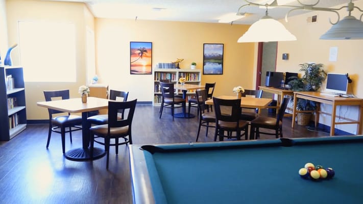 Interior view of a common area with dining tables and bookshelves