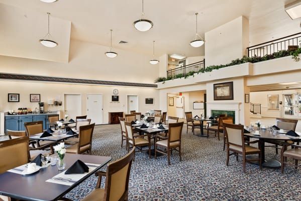 Bright and welcoming dining room with tables set for meals