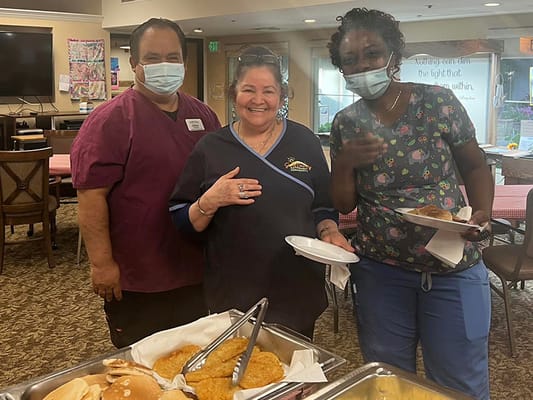 Staff members serving food in a dining area