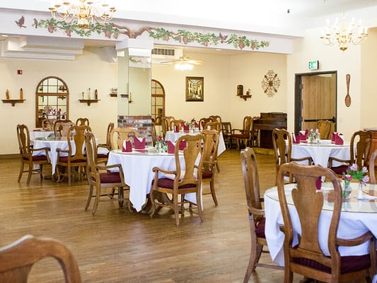 Dining area with tables and chairs set for a meal